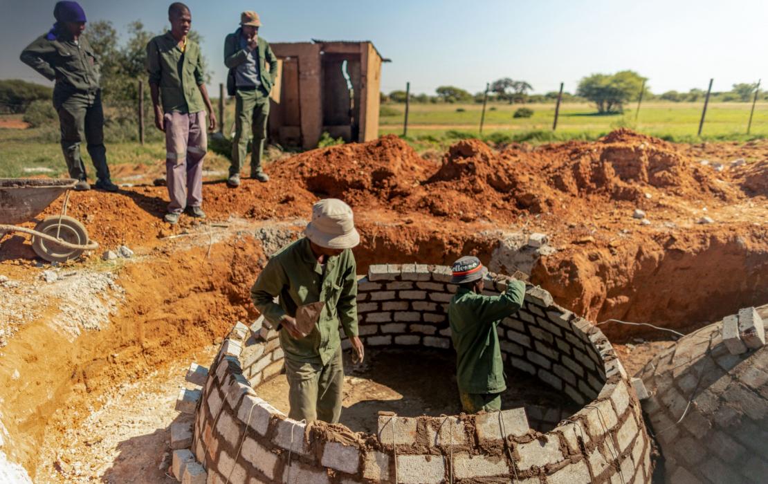 Students building a biodigester in Botswana