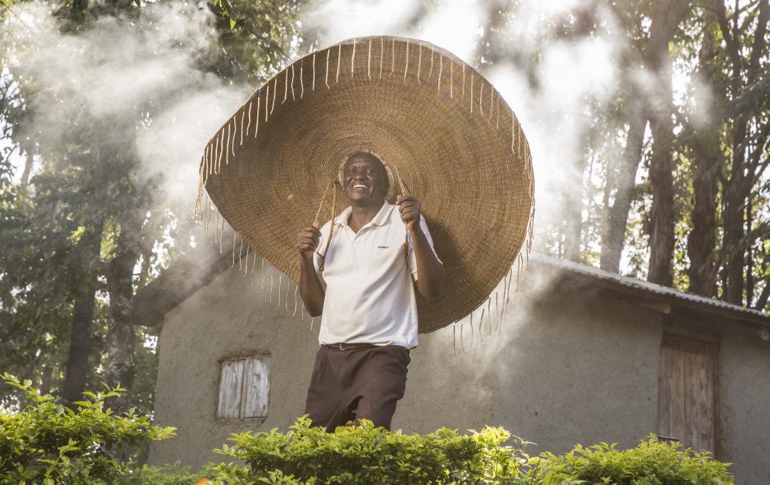 A forest conservationist wearing a big hat in a forest in Kenya