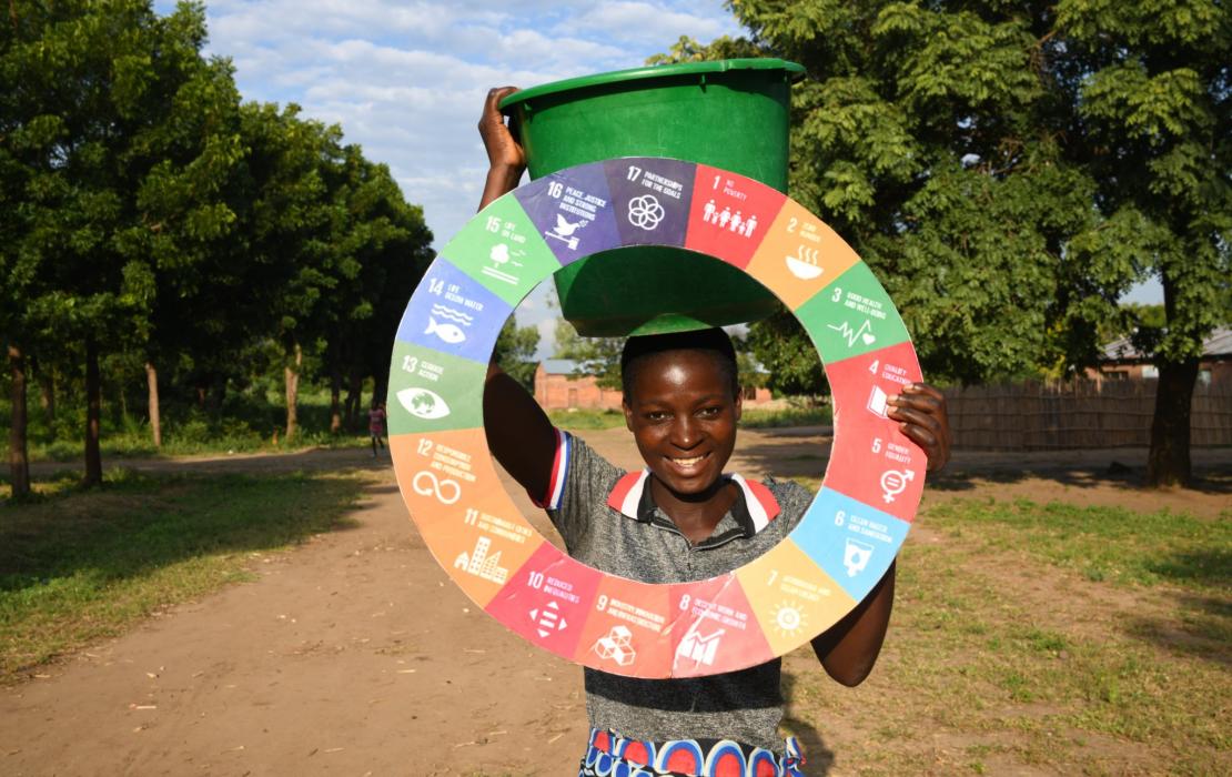 A woman holding the SDG wheel in Malawi