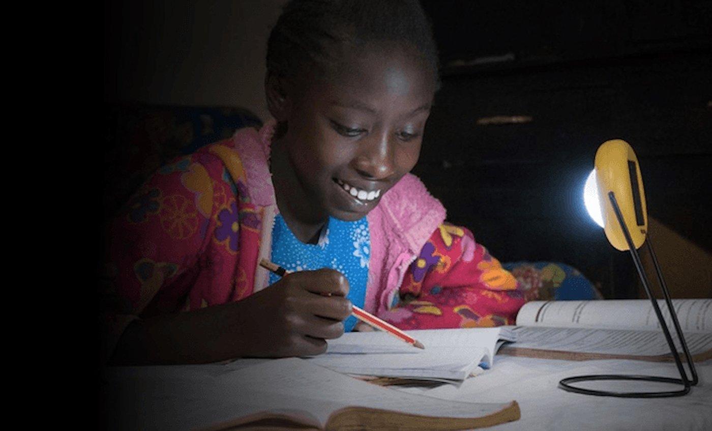 A girl studying with a solar lamp in Nigeria