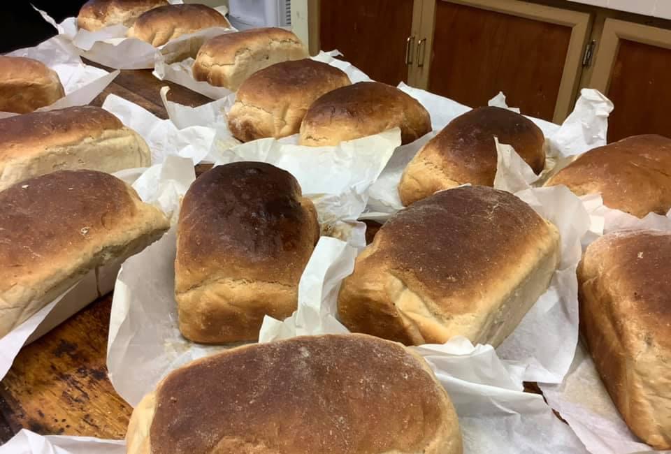Loaves of freshly baked bread made with locally milled flour.