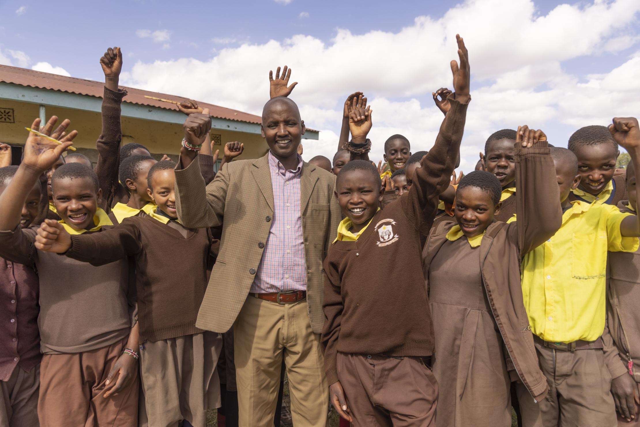 Pupils standing near their teacher in Kenya