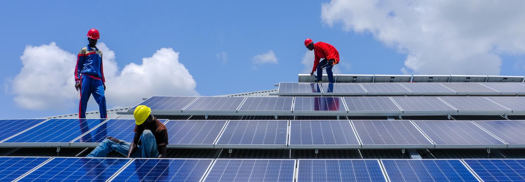 Men installing solar panels in South Sudan