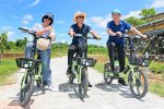 Three cyclists try out e-bikes in a Viet Nam park. Photo: UNDP Viet Nam
