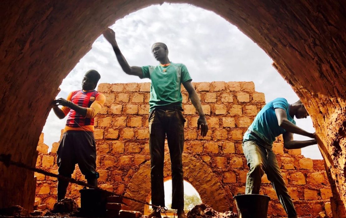 Three men work in the construction of Nubian Vault houses using a technique originating in upper Egypt