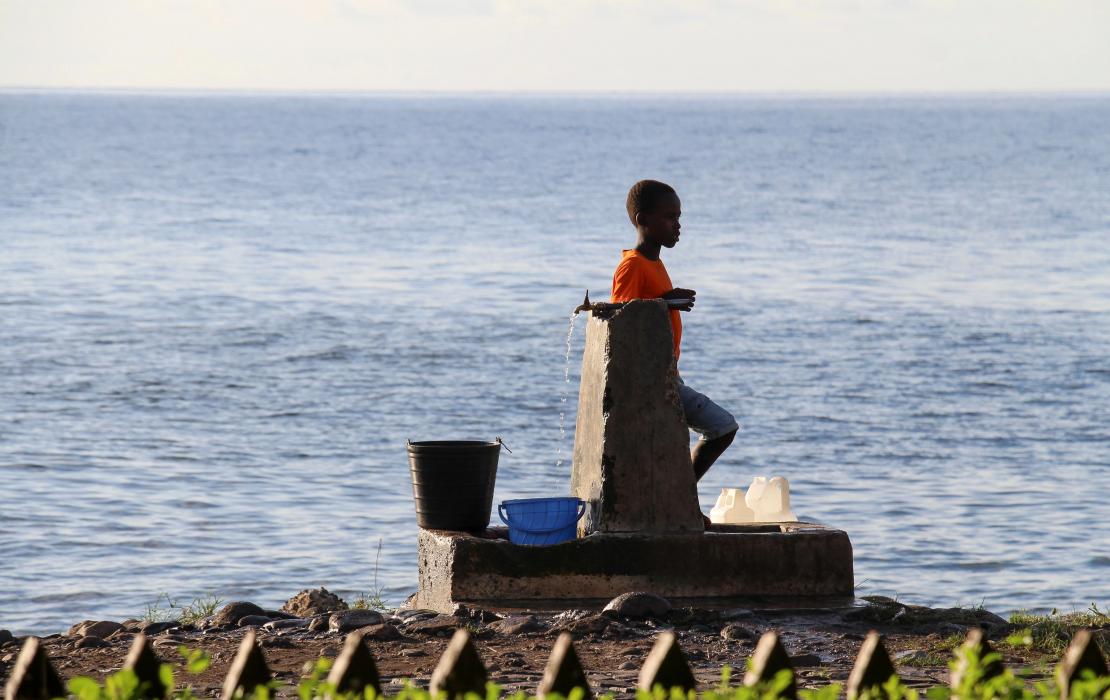 A boy standing by the sea in Sao Tome and Principe