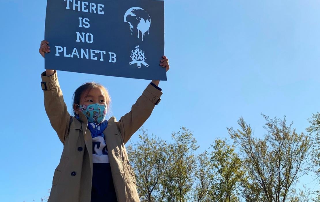 Young woman holding climate change sign in Kazakhstan