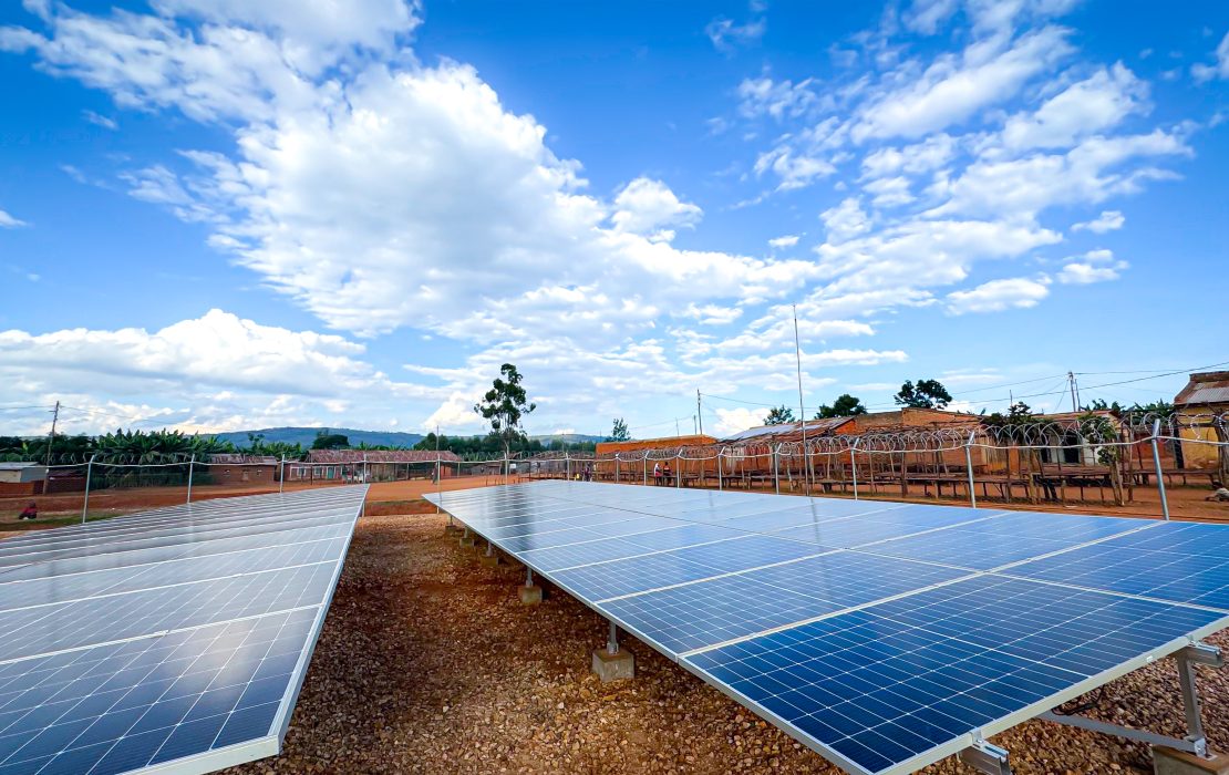 Youth working with a team to install solar panels.