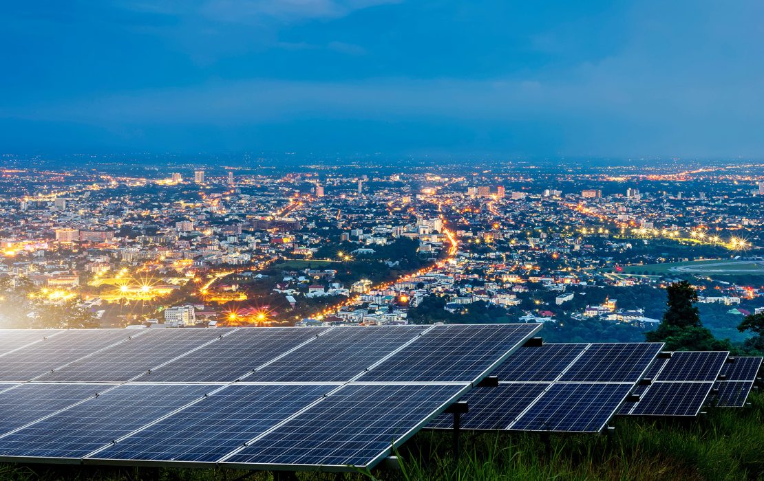 A view of solar panels overlooking a city