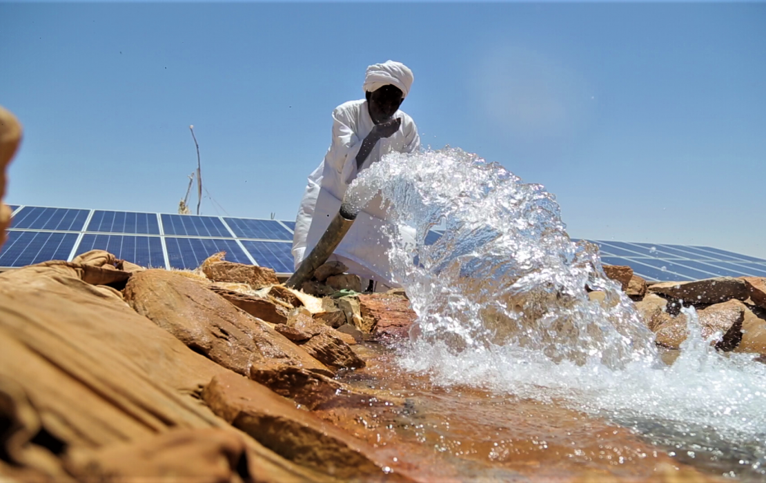 A farmer using a solar water pump in his field in Sudan