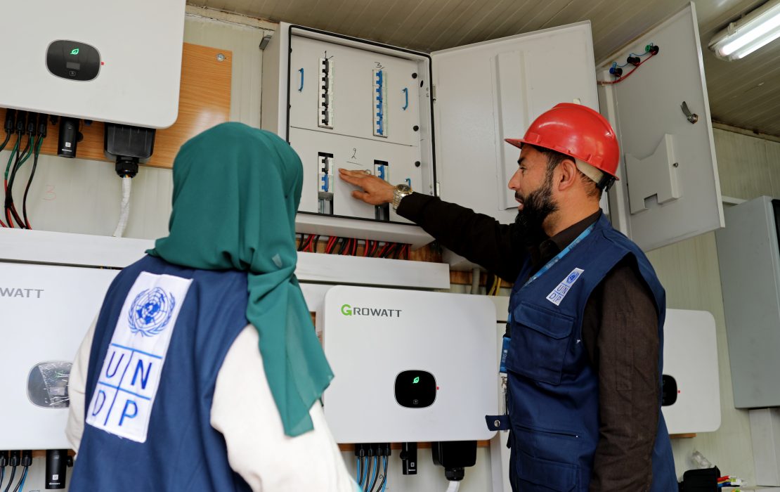 Technicians working on solar power inverter systems, Kabul, Afghanistan