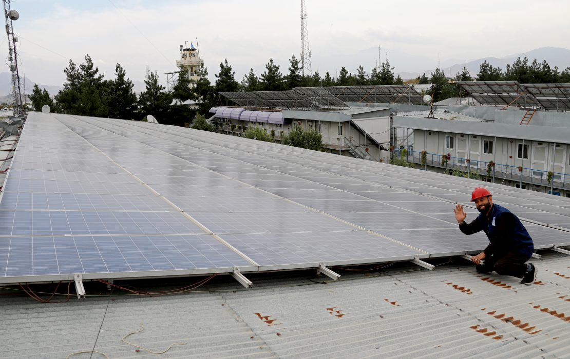 Solar panels being cleaned and serviced by engineers, Kabul, Afghanistan