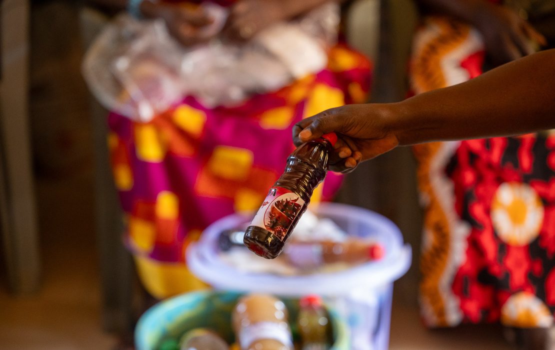 Small- and medium-sized enterprises account for nearly 90 percent of businesses in Senegal. Photo: UNDP Senegal Close-up of a hand holding a locally produced bottle of hibiscus (bissap) juice, with other homemade beverages in the background during a community market or small business showcase in Senegal.