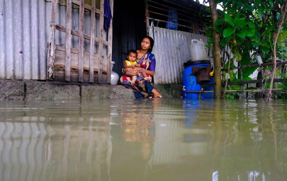 Bangladesh’s Nationally Determined Contribution acknowledges the health sector's vulnerability to climate change impacts and outlines steps to address climate change in a way that also improves the health and well-being of people. Photo: AB Rashid / UNDP Bangladesh A woman holds her child on the doorstep of a flooded home in Bangladesh—highlighting the urgent need to strengthen health and community resilience to climate change and extreme weather.