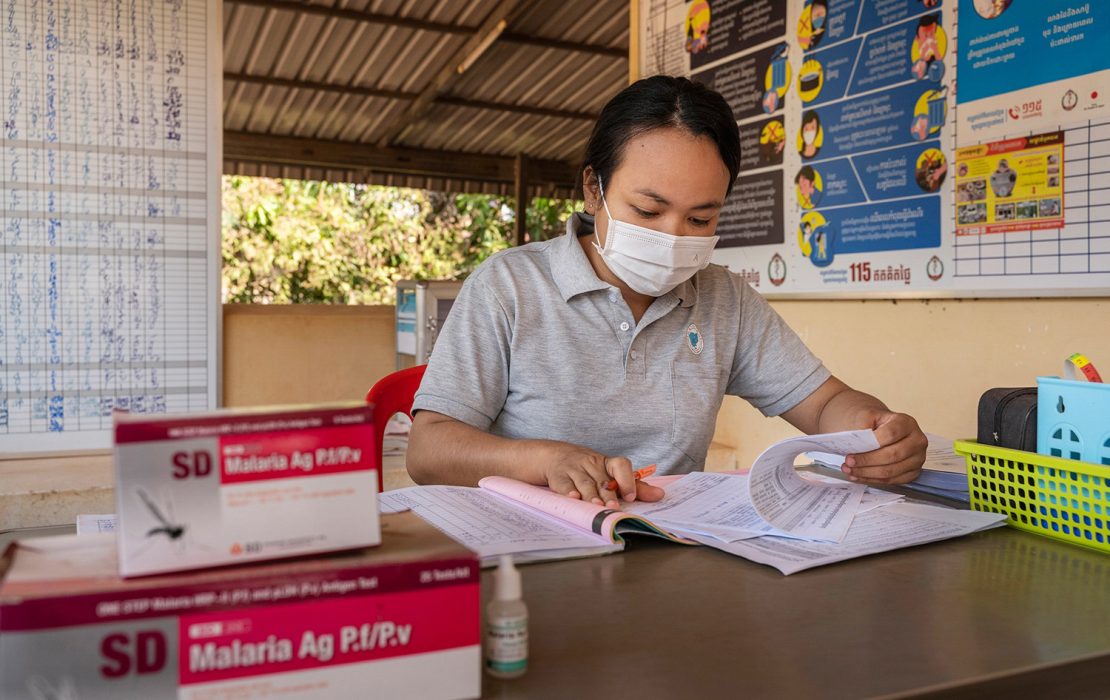 Cambodia has developed standard operating procedures for dengue and surveillance and rapid diagnostic testing, using them as a basis for training 120 doctors, nurses and other health professionals from high-risk provinces. Photo: WHO Cambodia A healthcare worker in Cambodia reviews disease surveillance data alongside malaria testing kits. Nationwide efforts are underway to strengthen health systems against climate-sensitive disease outbreaks linked to climate change.