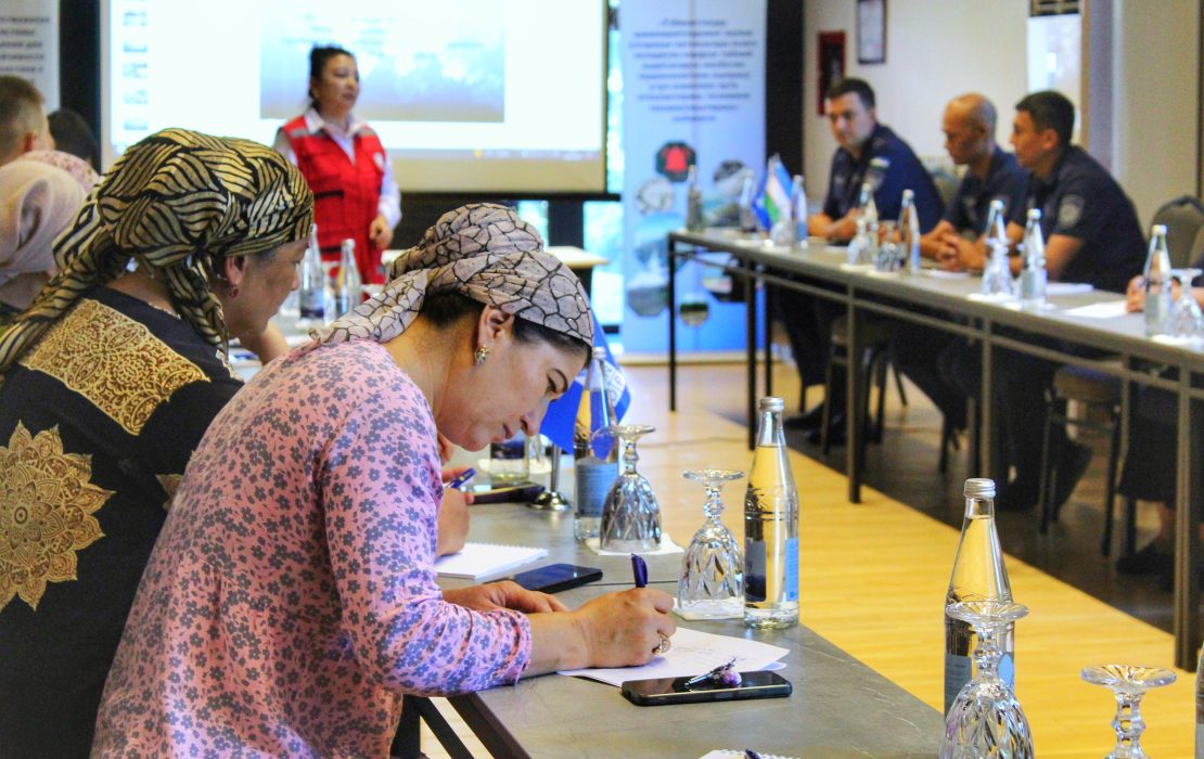 By improving access to reliable climate data, Uzbekistan’s new national framework is turning information into action across the economy. Communities are being trained on how to act before, during and after emergencies. Photo: UNDP Uzbekistan Community members in Uzbekistan take part in a disaster preparedness training, with women in the foreground writing notes as a facilitator speaks.