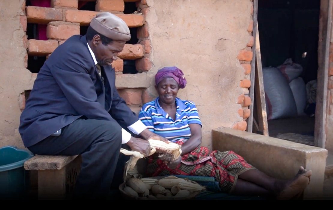Farmers such as Winston Kanyenda from Malawi are being trained in climate-smart agriculture, adapting their crops and planting schedule to a changing climate. Photo: UNDP Malawi Winston Kanyenda and his wife sit outside their home, smiling as they husk maize together.