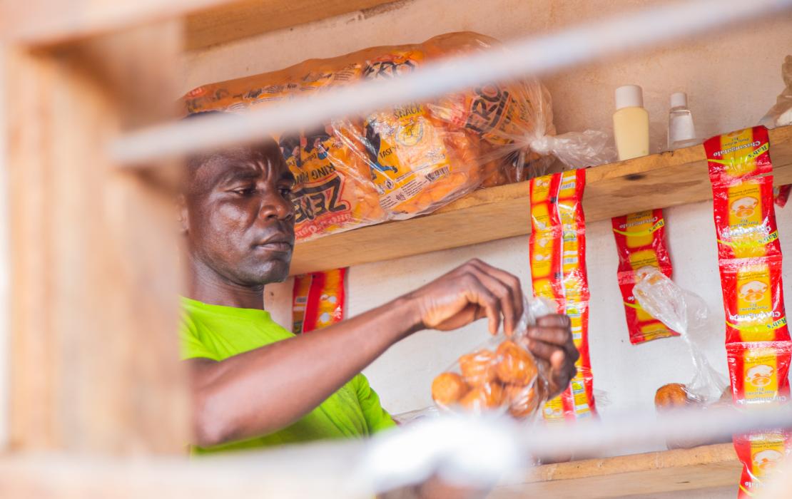 A man selling goods at a local shop in Malawi