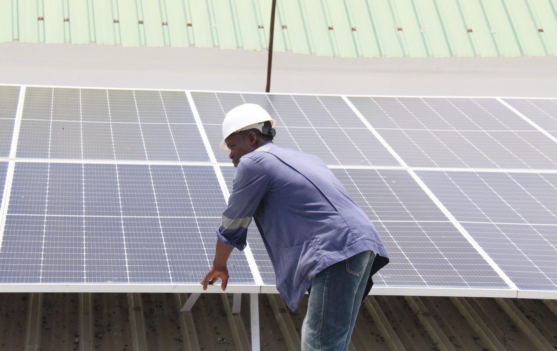 Engineer observing operation of solar panels at UNDP Benin