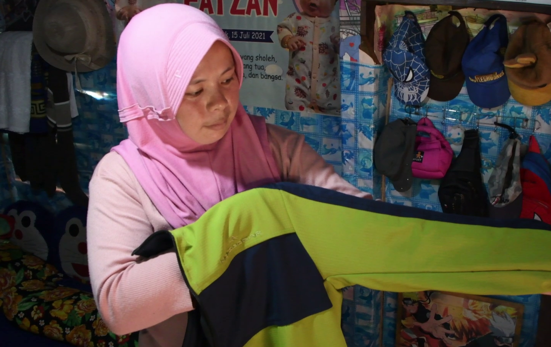 Ibu Nilis, a weaver in the community, has seen her productivity increase thanks to an electric loom