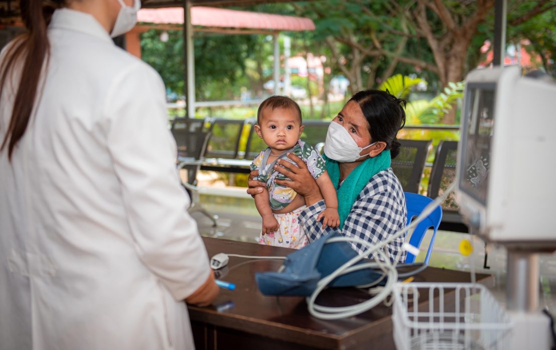 Cambodia’s Nationally Determined Contribution recognizes the impact of climate change on health, especially affecting children and the elderly, setting out five priority actions for adaptation. Photo: WHO Cambodia/Aforative Media A mother holds her baby during a health check-up at a clinic in Cambodia. National efforts are underway to strengthen healthcare systems against climate-related health risks and improve community resilience.