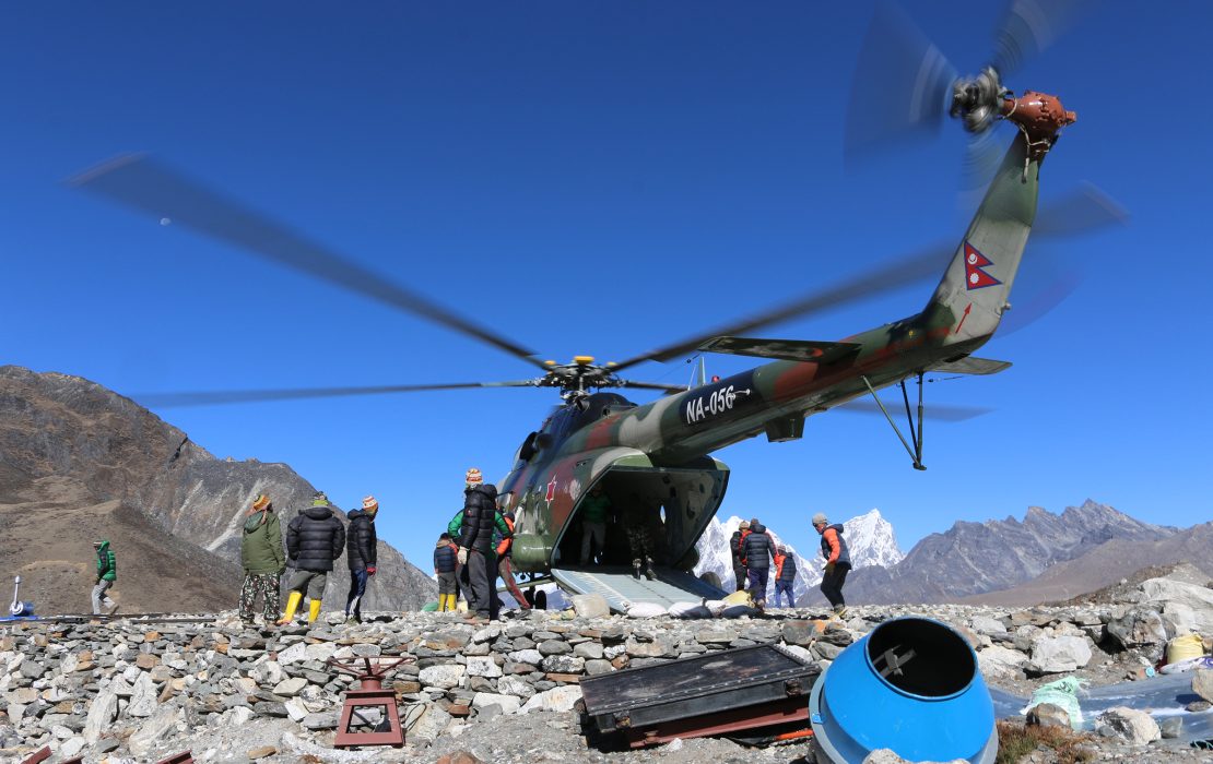 A Nepal Army helicopter delivers materials during operations to lower Imja Lake. 