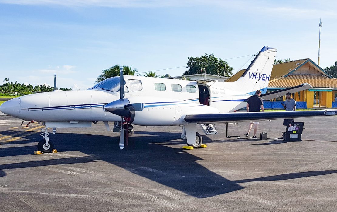 A small airplane waiting on the tarmac to take off.