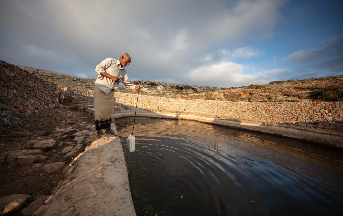 A man fetching water from a rainwater reservoir constructed by UNDP in Socotra