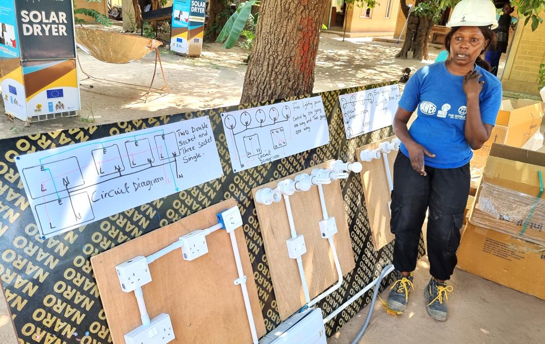 An electrician woman providing a training in The Gambia