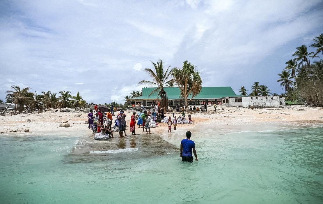 The community of Nui island waves goodbye to the Prime Minister of Tuvalu and his delegation visiting after Cyclone Pam