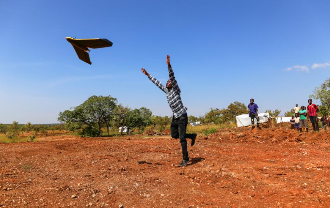 A man running in a field in Uganda