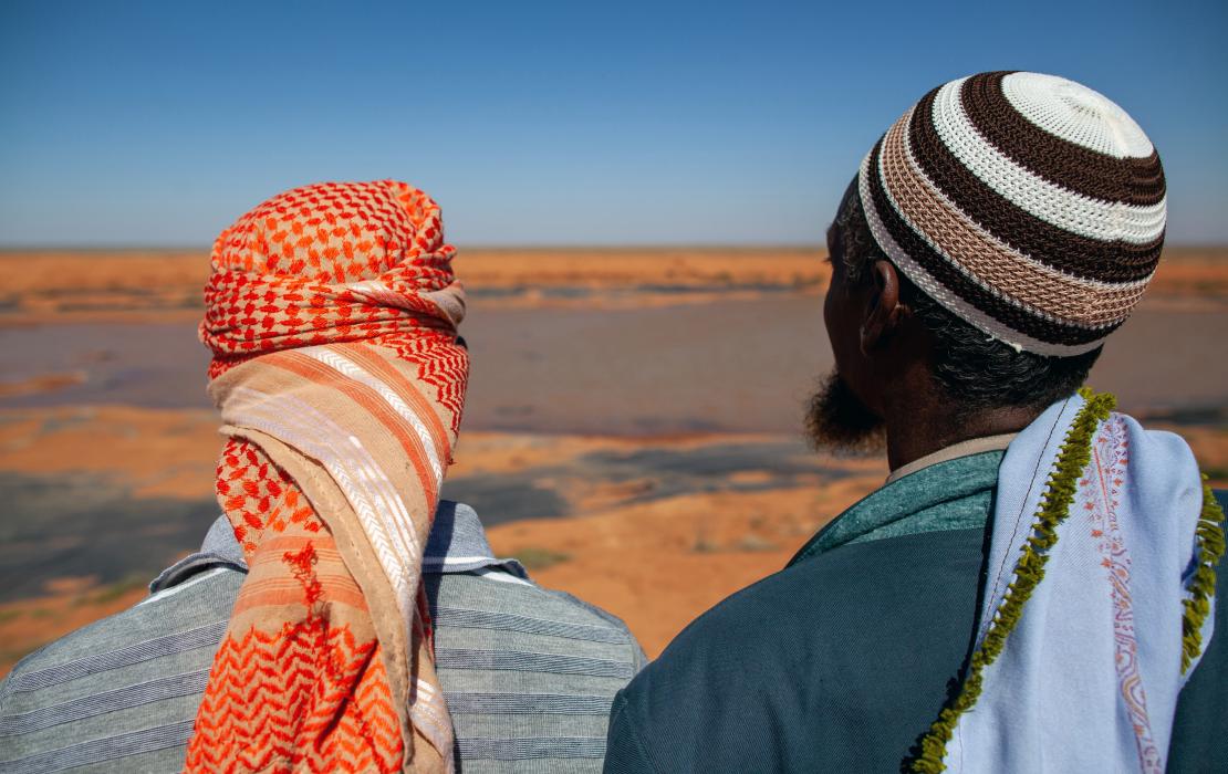 Woman and man in Somalia looking at the horizon