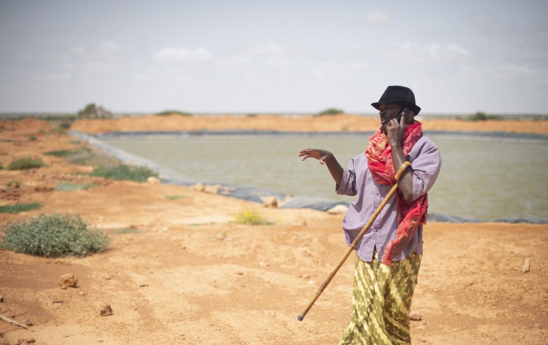 Man from Somalia next to water dam