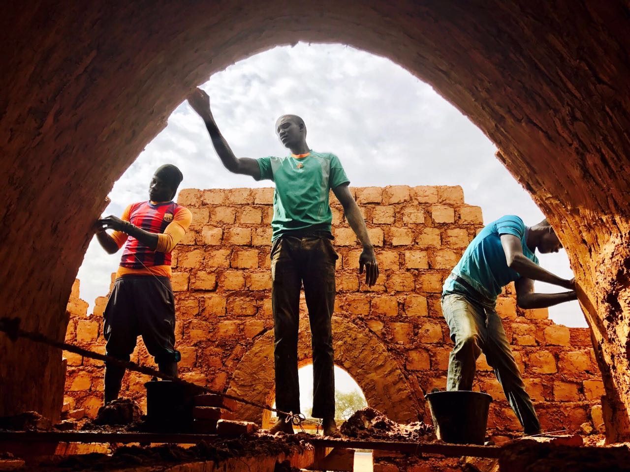 Photo: Nubian Vaults Association Three men work in the construction of Nubian Vault houses using a technique originating in upper Egypt