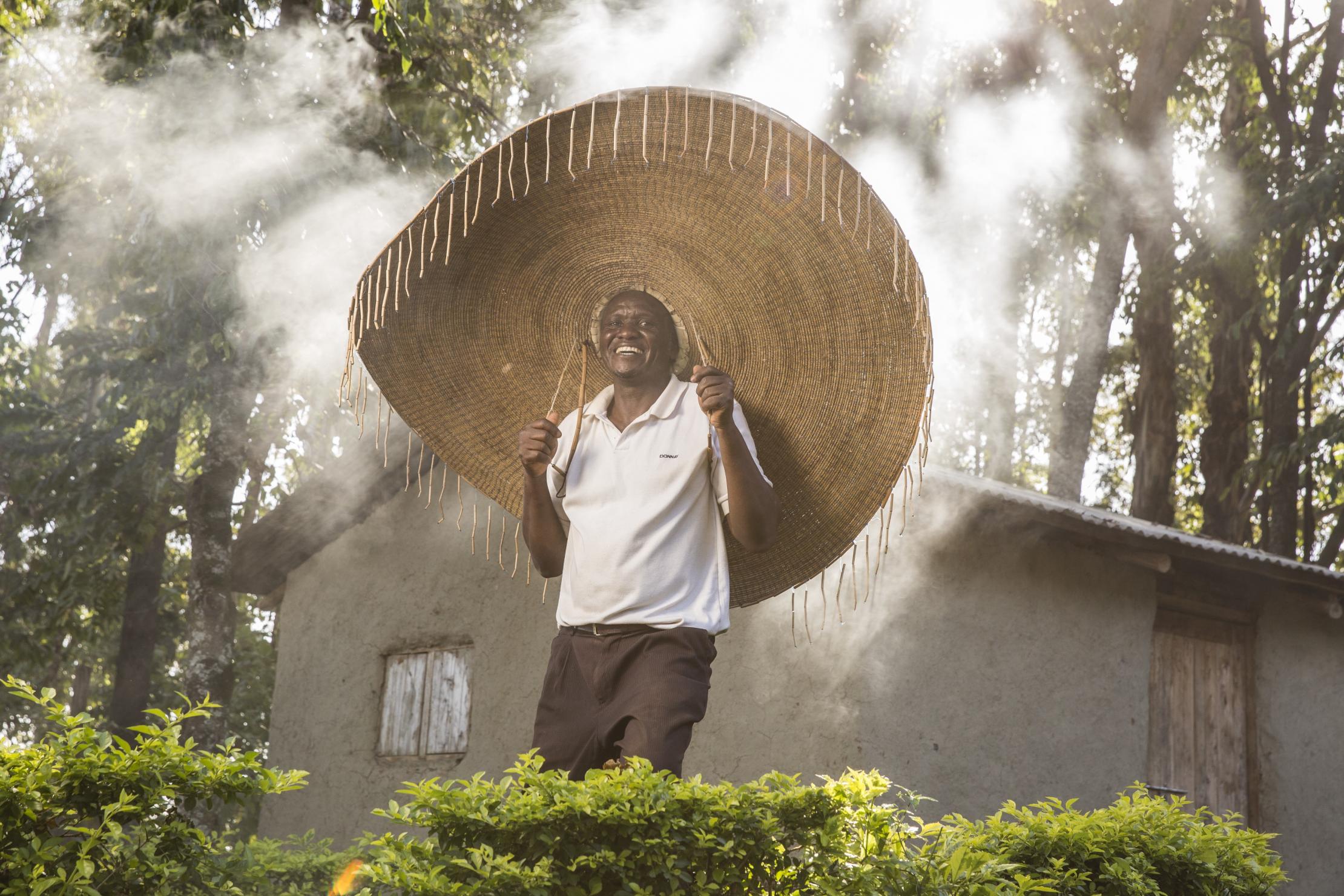 A forest conservationist wearing a big hat in a forest in Kenya