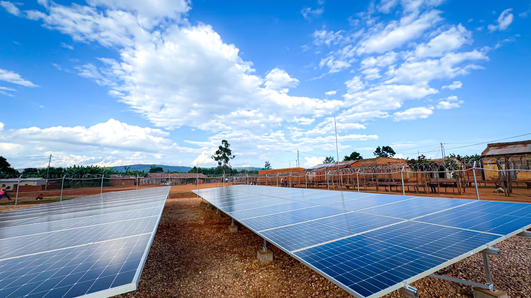 Youth working with a team to install solar panels.