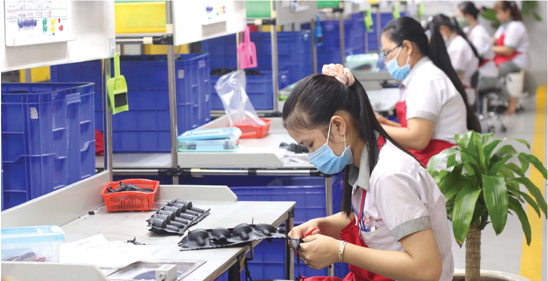 A woman is working at a factory