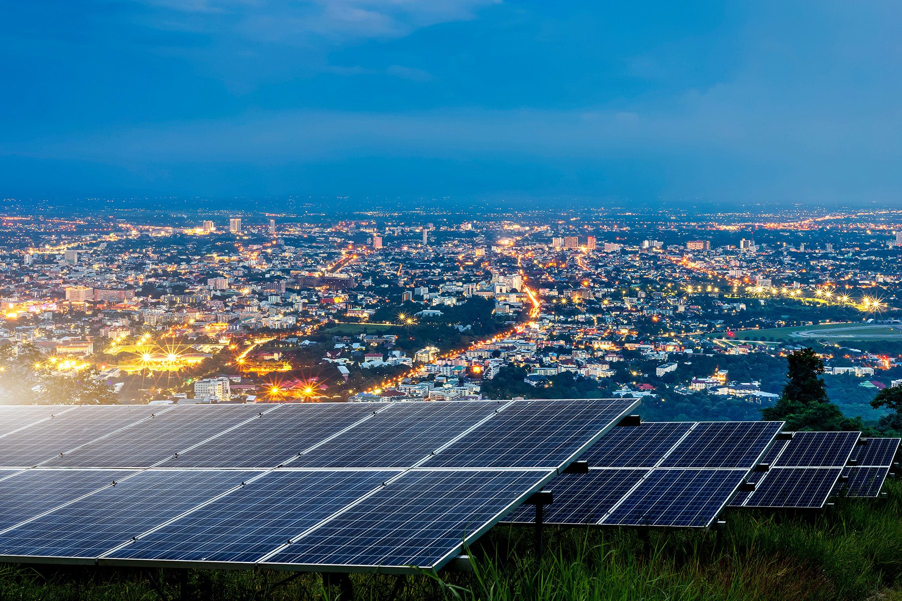 A view of solar panels overlooking a city