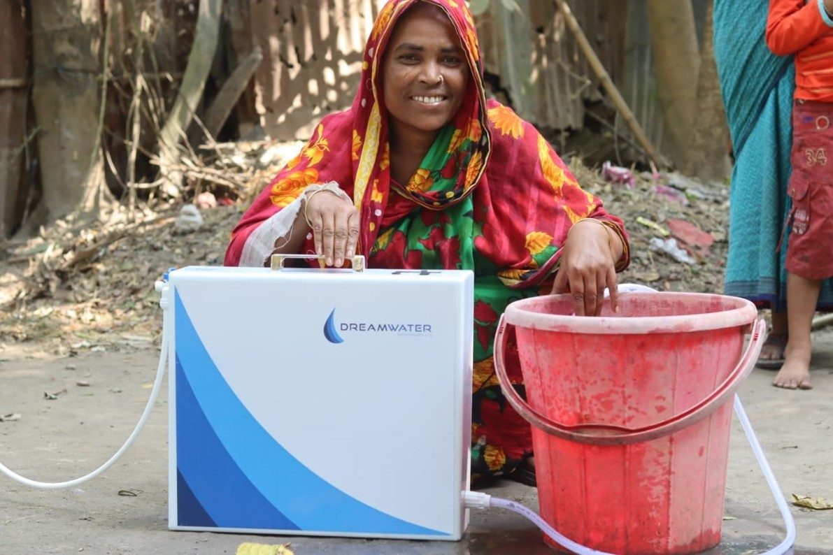 Rasna Islam posing with her Dreamwater portable filter after receiving training to become a water entrepreneur in Kushtia, Southwestern Bangladesh. Photo: Footsteps Rasna Islam posing with her Dreamwater portable filter