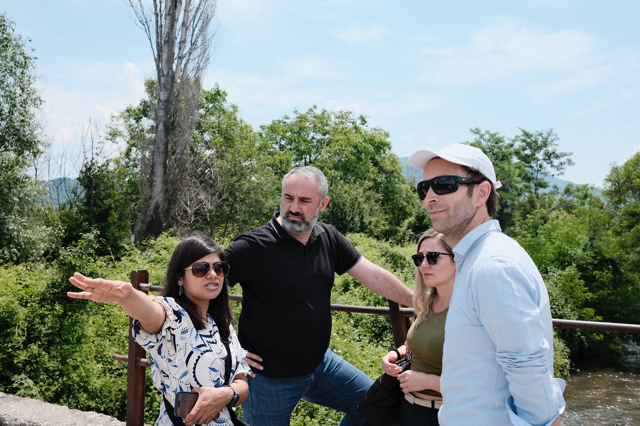 During a recent visit, a delegation from the Adaptation Fund praised North Macedonia’s work as a model for integrated, sustainable flood risk management. Photo: UNDP A group of Adaptation Fund and UNDP representatives stand outdoors in North Macedonia during a site visit, discussing flood risk management near a river.