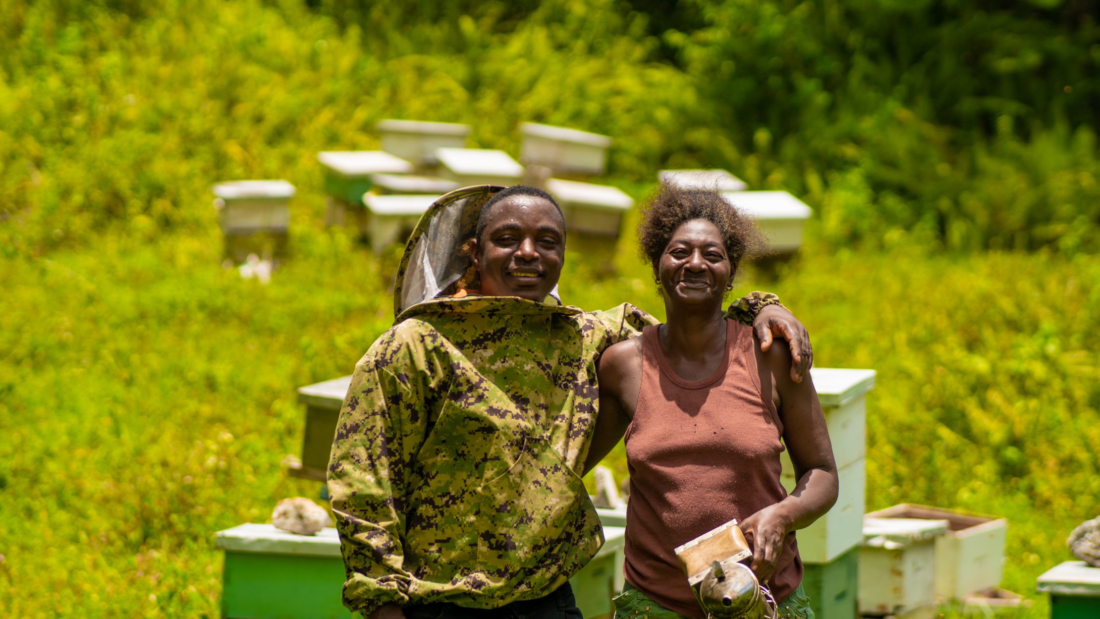 Jamaica's Long Term Strategy provides a long-term vision for sustainable, low-emission development through 2050 and emphasizes a just transition, economy-wide resilience, and inclusive growth. Two beekepers in Jamaica