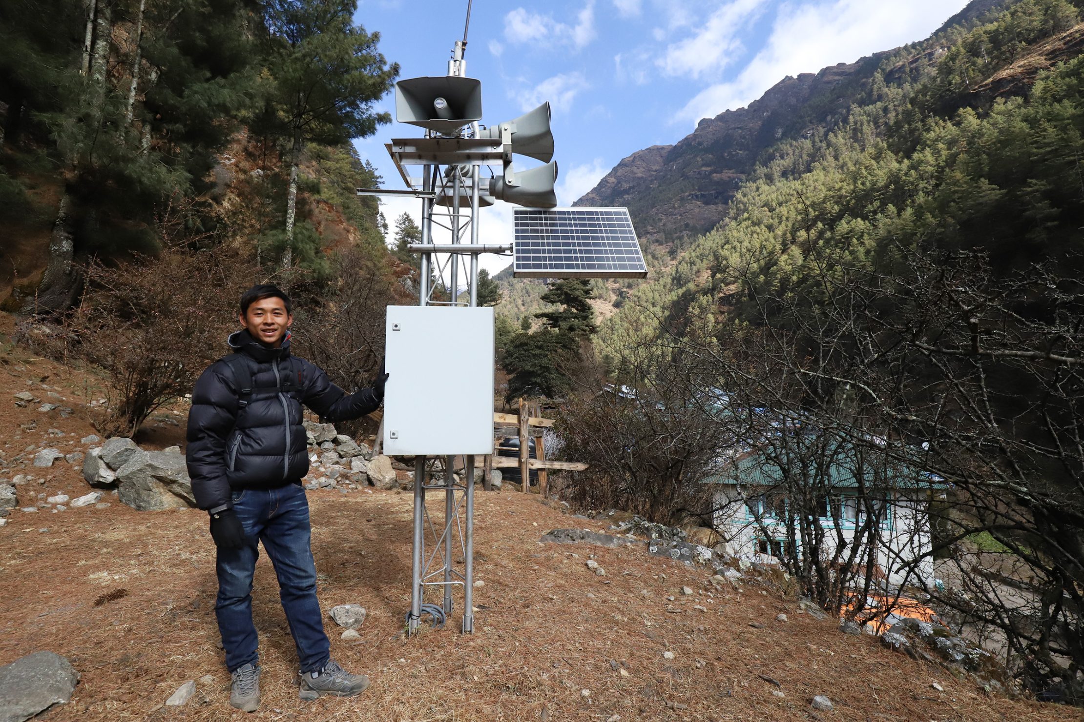 In the latest generation of NDCs, many countries have expanded on the uses of climate information. Nepal, for example, has committed to providing agro-meteorological advisories to all provinces by 2030. Photo: UNDP Nepal A man stands beside a solar-powered early warning siren installed in a mountainous area of Nepal.