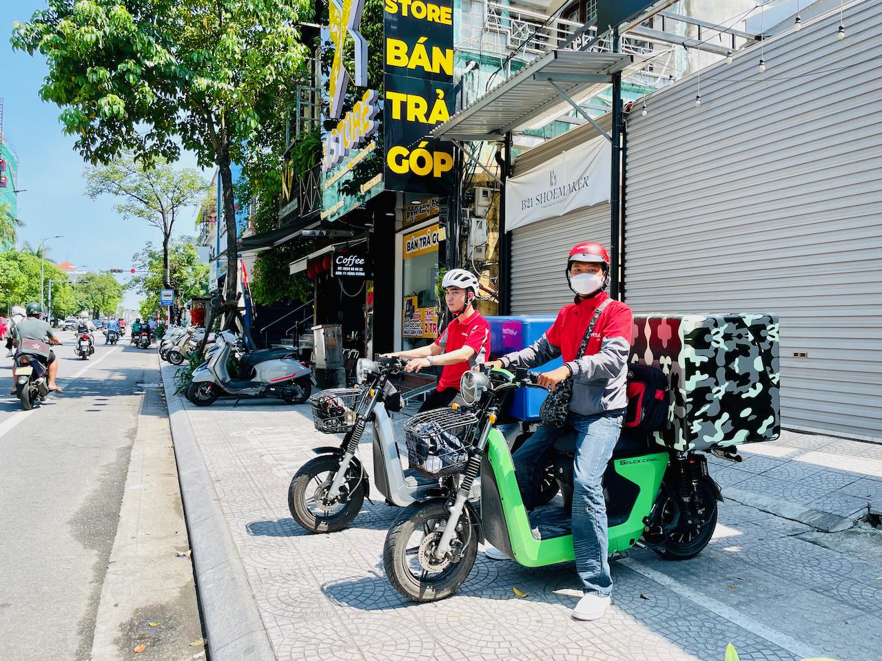 Tuan Anh and his colleague are using their new e-motorbikes for work.