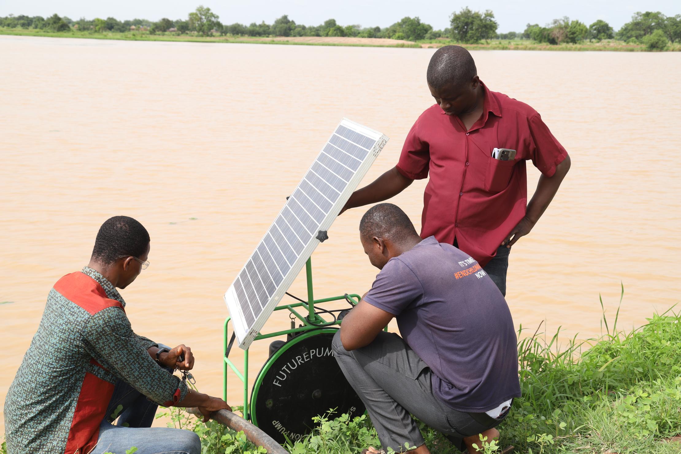 Open Ghana team re-positioning solar pumping machine