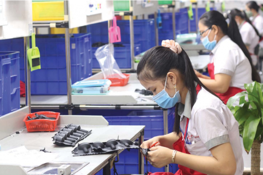 A woman is working at a factory