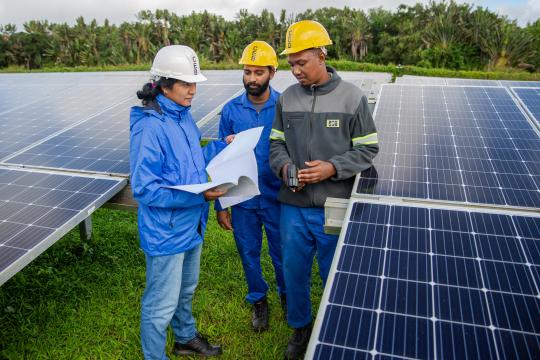 Woman engineer working with a team on installation of solar panels in Mauritius and the Seychelles