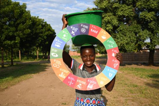 A woman holding the SDG wheel in Malawi