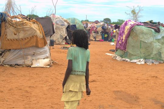 Photo : UNDP Namibia A gril walking in a settlement in Namibia