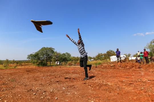 Photo : UNDP Uganda A man running in a field in Uganda