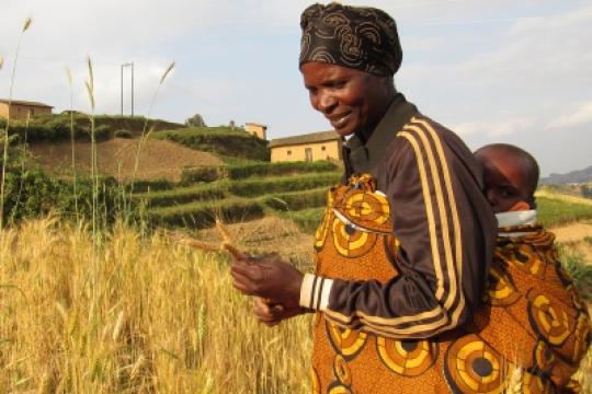 a woman in a field in Rwanda